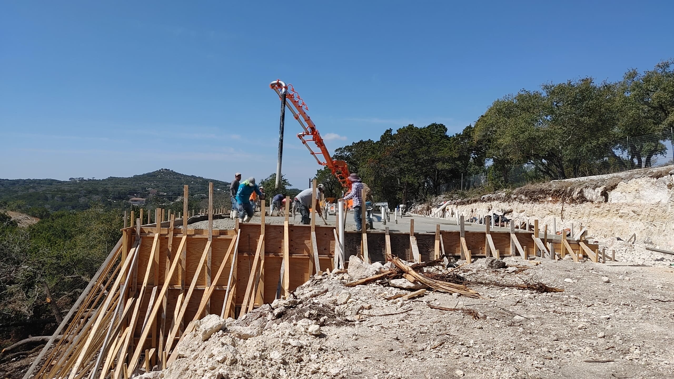 Steep Texas Hill Country lot with limestone terrain and a partially built home foundation